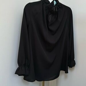 Black top with ruffle details